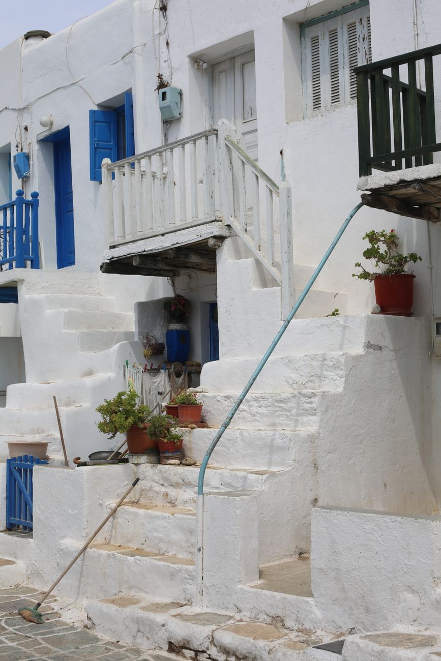 Whitewashed Greek terrace overlooking the turquoise Aegean