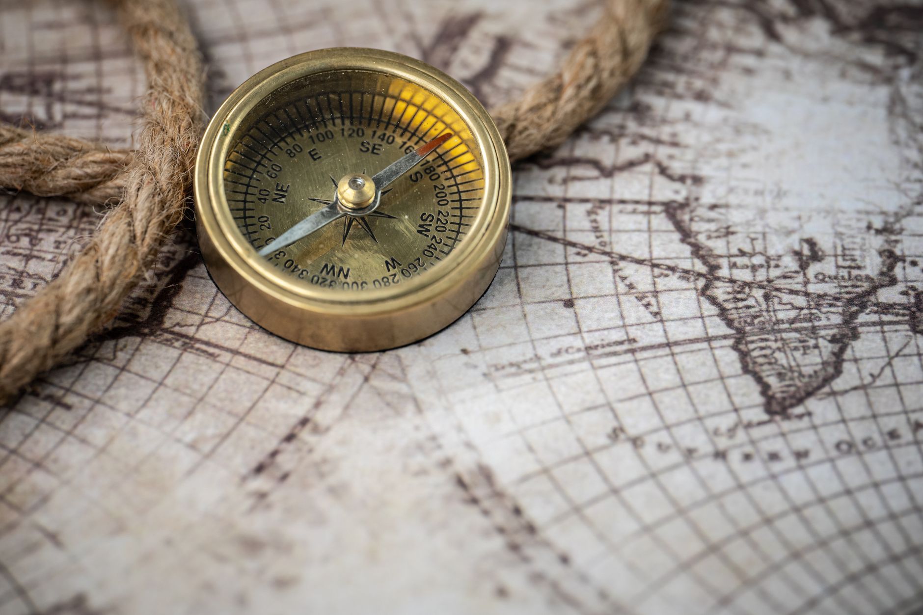 Vintage map and compass on rustic oak table
